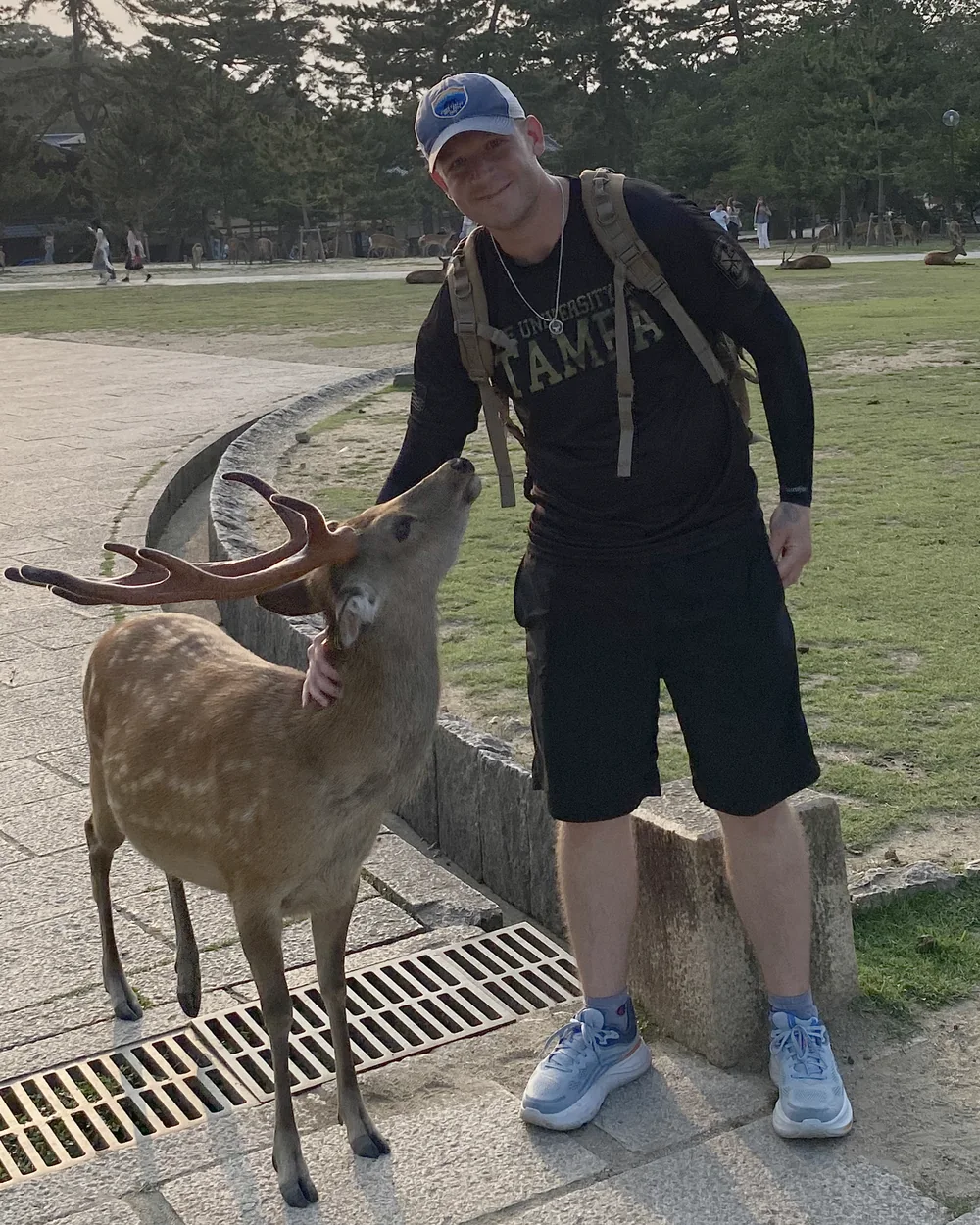 Fitz outdoors with a deer at sunset